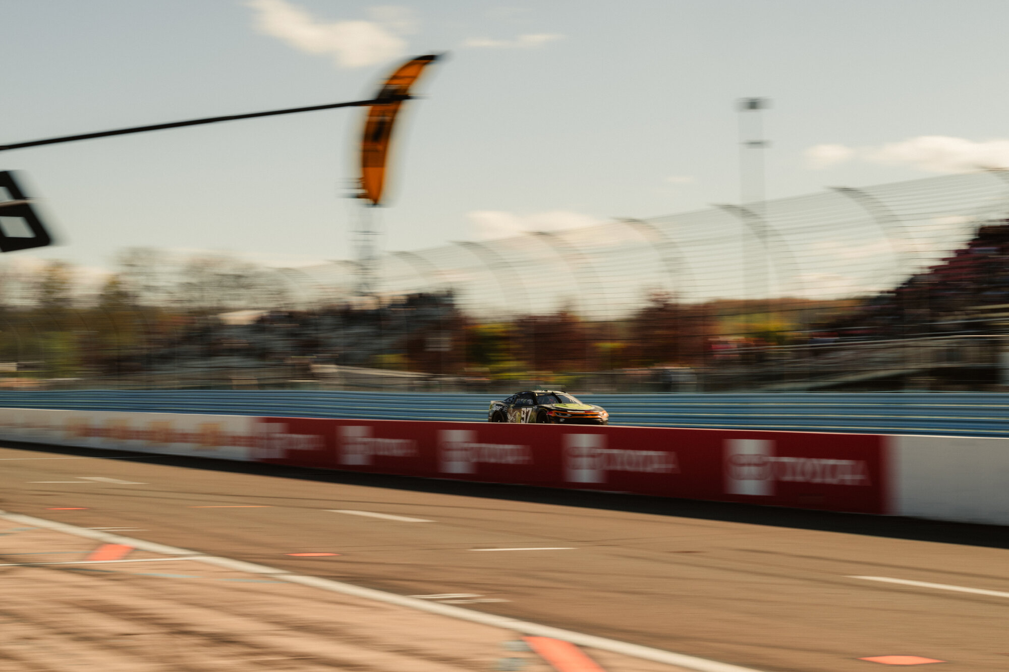 A Cup Series car races through a turn at Watkins Glen International