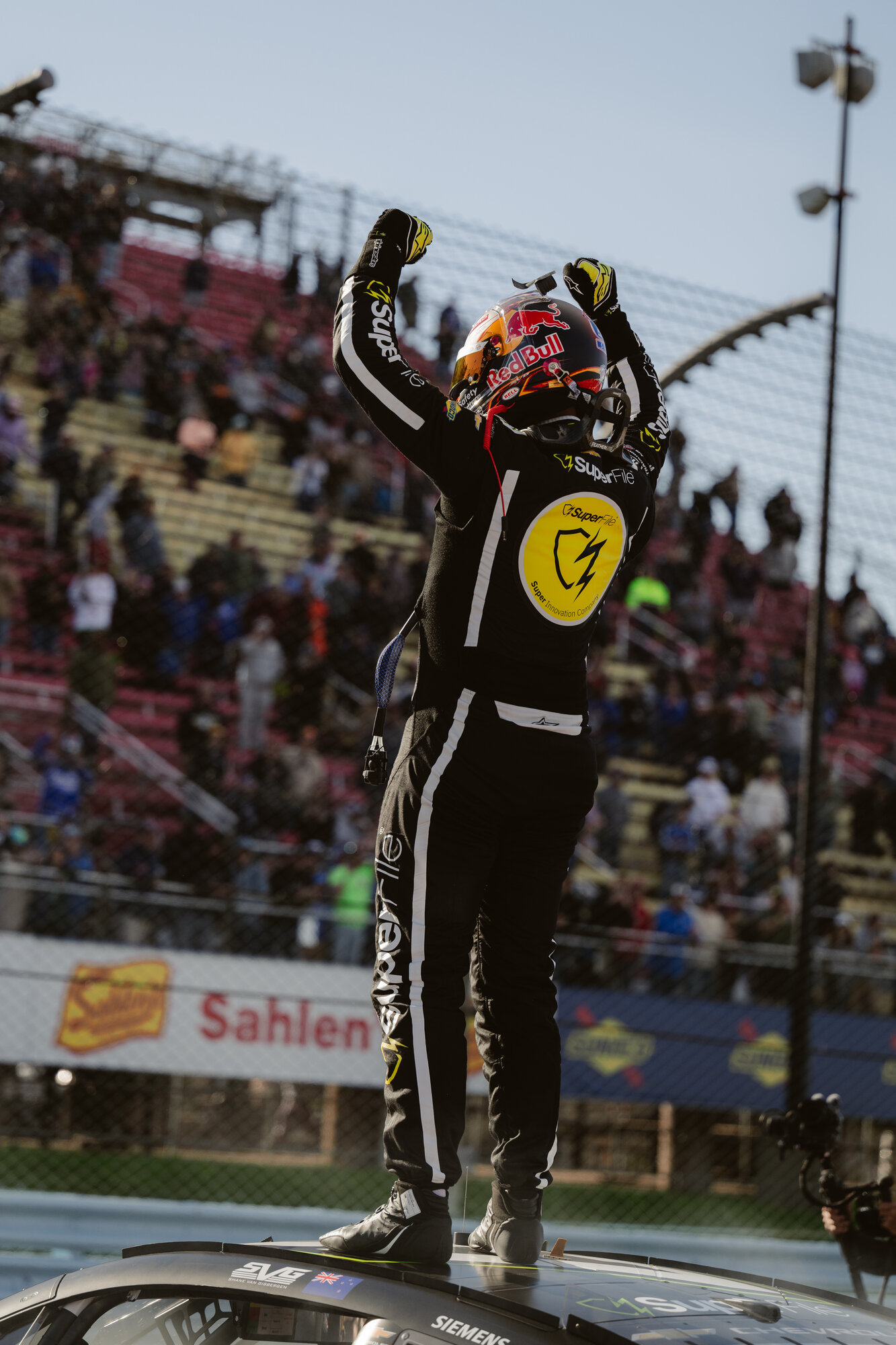 Shane van Gisbergen waves to the crowd after winning at Watkins Glen International
