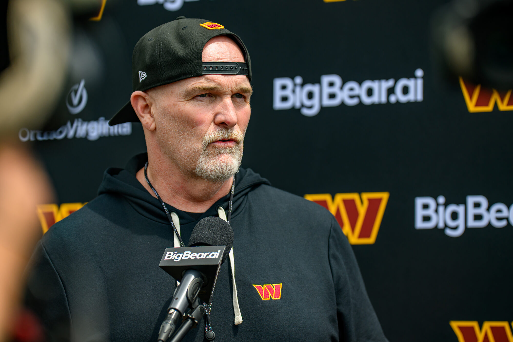 Washington Commanders head coach Dan Quinn speaks with reporters after OTA Session 3